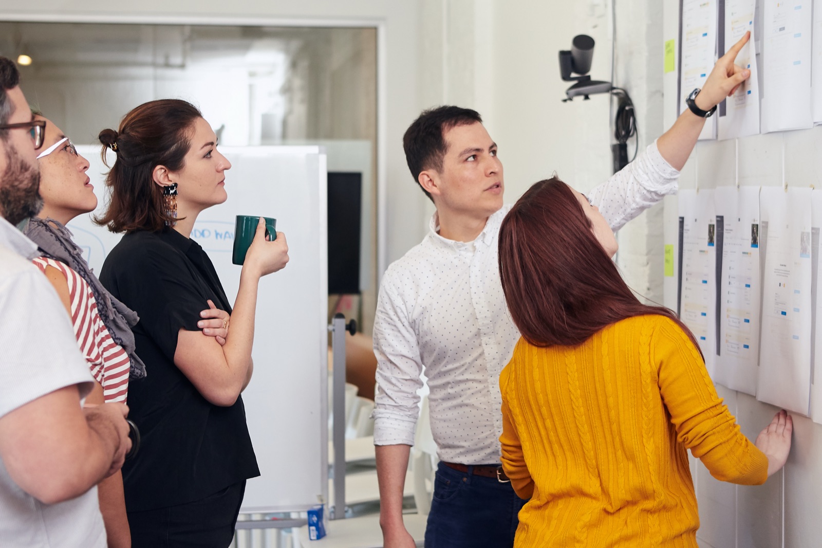 Engineers reviewing system architecture on a whiteboard